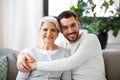 Senior mother with adult son hugging at home Royalty Free Stock Photo