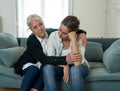 Mother and daughter crying at home in quarantine grieving loss of family members amid COVID-19 Royalty Free Stock Photo