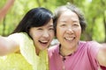 Senior mother and daughter taking selfie