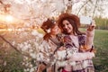 Senior mother and her adult daughter hugging and taking selfie in blooming garden. Mother`s day concept. Family values Royalty Free Stock Photo