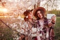 Senior mother and her adult daughter hugging and taking selfie in blooming garden. Mother`s day concept. Family values Royalty Free Stock Photo