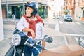 Senior motorcyclist man smiling happy wearing moto helmet at the city