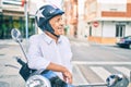 Senior motorcyclist man smiling happy wearing moto helmet at the city