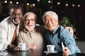 senior multicultural friends embracing and smiling Royalty Free Stock Photo