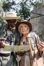 Senior multiethnic hikers with compass and Royalty Free Stock Photo
