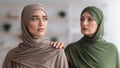 Senior Muslim Mother Touching Shoulder Of Unhappy Adult Daughter Indoor