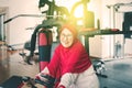 Senior muslim woman riding exercise bike in fitness center Royalty Free Stock Photo