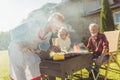 Senior neighbors having backyard barbecue party