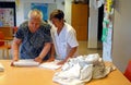 Senior and nurse at the laundry daily works on a nursing home in Mallorca