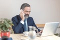 Elderly business man in a coffee shop Royalty Free Stock Photo