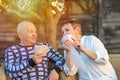 Senior old couple playing cards game at park on sunny day. Royalty Free Stock Photo