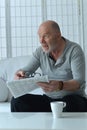 Senior old man reading newspaper at home Royalty Free Stock Photo