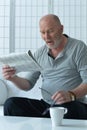 Senior old man reading newspaper at home Royalty Free Stock Photo