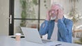 Senior Old Man having Headache while using Laptop in Office Royalty Free Stock Photo