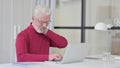 Old Man having Neck Pain while working on Laptop Royalty Free Stock Photo