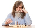 Senior Old Man playing Chess. Thoughtful Elder Pensioner thinking about Strategy, looking at Chessboard. Grandfather with Gray Royalty Free Stock Photo