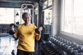 Senior strong man dumbbell exercise in gym