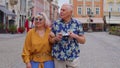 Senior old stylish tourists man, woman, grandmother, grandfather family having a walk in summer city Royalty Free Stock Photo