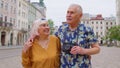 Senior old stylish tourists man, woman, grandmother, grandfather family having a walk in summer city Royalty Free Stock Photo