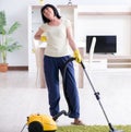 Senior old woman tired after vacuum cleaning house Royalty Free Stock Photo
