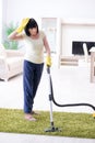 The senior old woman tired after vacuum cleaning house Royalty Free Stock Photo
