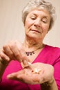 Senior older lady taking a tablet or pill Royalty Free Stock Photo