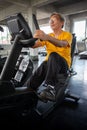 Senior older man exercising on cycling machine relaxing in fitness gym. aged . Old male workout .Mature sport training. Royalty Free Stock Photo