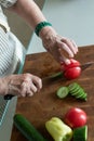 Senior or older woman cooking salad in kitchen. Healthy food concept. Healthy lifestyle. Grandma prepares a healthy meal for her Royalty Free Stock Photo