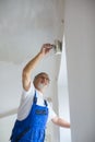 Senior painter man at work with a paint bucket