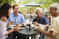 Senior Parents With Adult Children Enjoying Meal At Outdoor Cafe Royalty Free Stock Photo