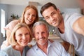 Senior Parents With Adult Offspring Posing For Selfie At Home Royalty Free Stock Photo