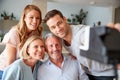 Senior Parents With Adult Offspring Posing For Selfie On Vintage Instant Film Camera Royalty Free Stock Photo