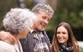 Senior parents, hug and outdoor with daughter, adult and happy with humor and bonding together. Nature, old mother or Royalty Free Stock Photo