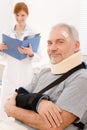 Senior patient broken arm in doctor office Royalty Free Stock Photo