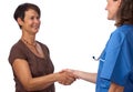 Senior patient greeting her doctor with handshake