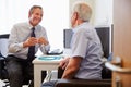 Senior Patient Having Consultation With Doctor In Office Royalty Free Stock Photo