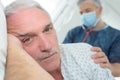 Senior patient on side in hospital bed Royalty Free Stock Photo