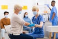 Senior Patient Lady Getting Vaccinated Against Coronavirus Sitting In Hospital Royalty Free Stock Photo