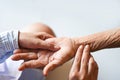 Senior patient and nurse - Pulse measurement by hand check the heart beat patient hand for a radial pulse by touching fingers Royalty Free Stock Photo