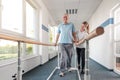 Senior Patient and physical therapist in rehabilitation walking exercises Royalty Free Stock Photo