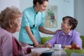 Patient of professional nursing home and helpful young nurse