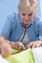 Senior pediatrician examining boy