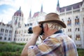 Senior pensioner photographing Parliament Building Budapest Royalty Free Stock Photo