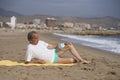 Senior pensioner sitting relaxed on the beach - retired old man on his 70s looking at the sea thoughtful and contemplative with