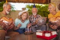 Senior people blowing candles on a birthday cake Royalty Free Stock Photo
