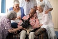 Senior people and doctor playing with dog Royalty Free Stock Photo