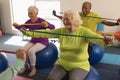 Senior people exercising with resistance band in fitness studio Royalty Free Stock Photo