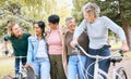 Senior people, friends and laughing on bike in joyful happiness enjoying fun time together at the park. Group of elderly Royalty Free Stock Photo