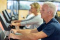 Senior people in gym spinning on fitness bike Royalty Free Stock Photo