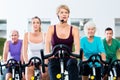 Senior people in gym spinning on fitness bike Royalty Free Stock Photo